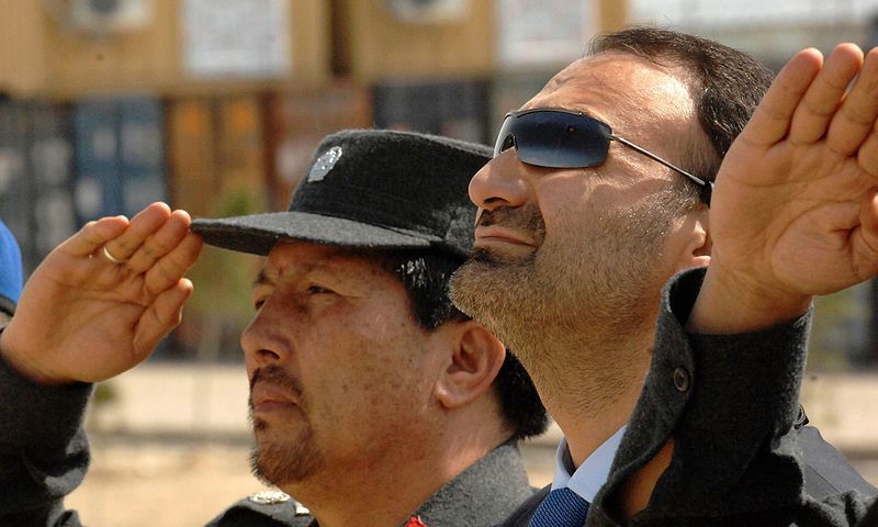 A_senior_ANCOP_Afghan_Gendarmerie_Force_police_officer_and_Mohammad_Atta_Noor_pay_their_respects_to_the_Afghan_flag_4466443705