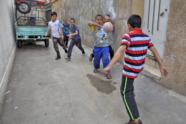 depositphotos_166532676-stock-photo-iranian-street-boys-playing-soccer